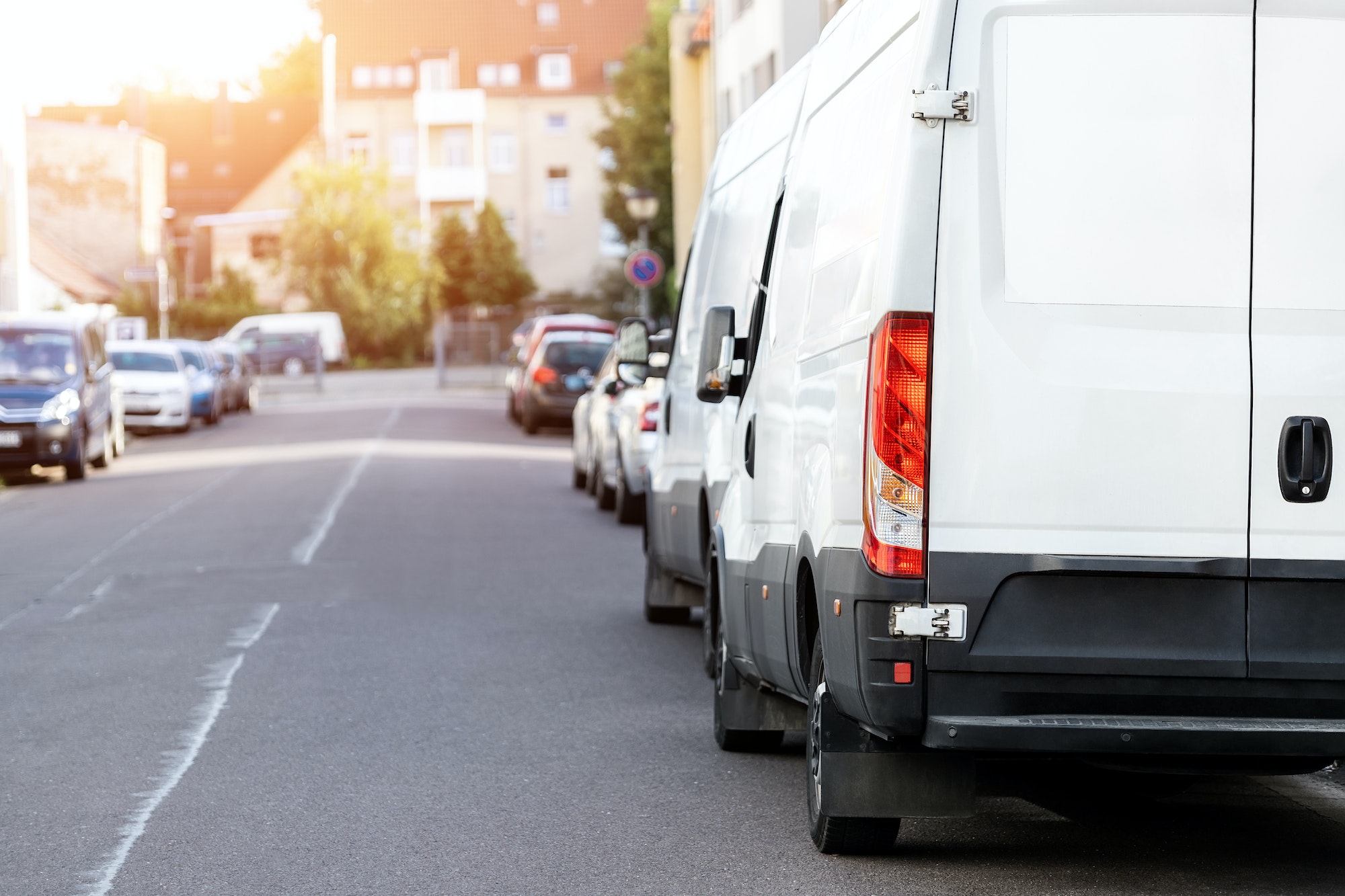 Small cargo delivery van parked in european city central district. Medium lorry minivan courier